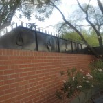fence on brick wall with lyre design image