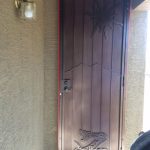 brown custom security screen door with snake design image