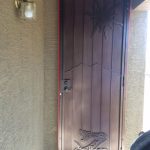 brown custom security screen door with snake design image