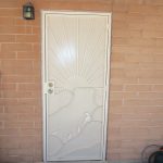 white custom security door with quail design from the larger company tucson image